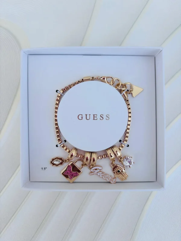 Pulsera Guess en Dorado  chams candado mariposa